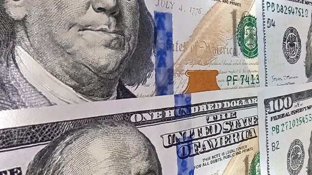 Smooth motion across layered 100 dollar bills presenting an exclusive financial background designed around investment concepts, monetary value, business growth and active cash movement