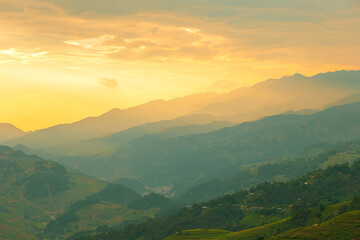 Fototapeta premium Beautiful sunset in the mountains. The Mu Cang Chai rice terraces in Vietnam.
