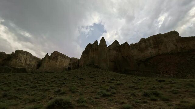 Horizontal panning shot of eroded rock formations and cliffs
