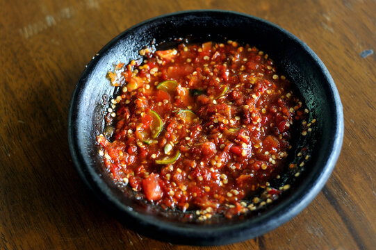 Sambal terasi (chili paste with shrimp paste) freshly ground and served in a stone mortar (cobek).