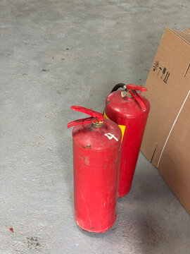 Industrial fire suppression system room with red gas fire-extinguishing cylinders and high-pressure pipes, safety system