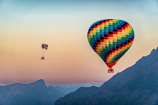 a hot air balloon and a motor paraglider at Vang Vieng in Laos