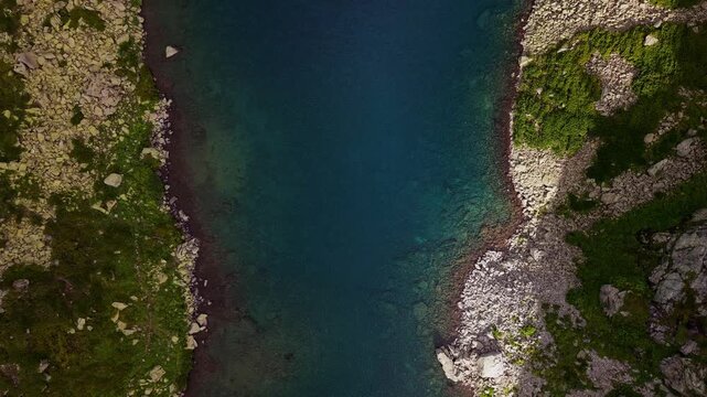 Aerial view of a narrow river channel with rocky banks