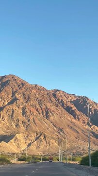 Mountain road through the Southern Edom Mountains, desert driving, rocky terrain near Aqaba, Jordan landscape, arid wilderness