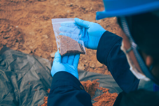Soil quality monitoring conducted by environmental personnel through field sampling.
