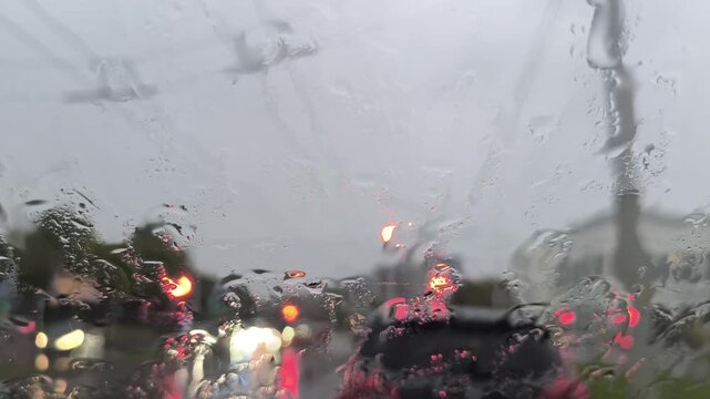 Raindrops and snow slowly disappear on the glass