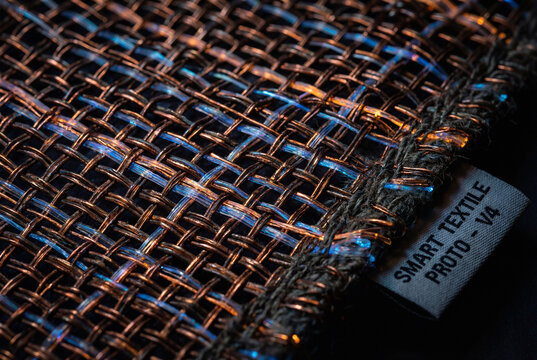 Fabric texture woven with copper wires and fiber optics, concept of smart wearable technology