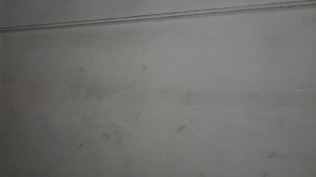Grungy interior room corner featuring dark dirty wall textures
