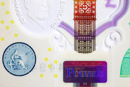 5 British Pound polymer banknote featuring the transparent window with Big Ben, metallic crown hologram, and portrait watermark of King Charles III. UK national currency