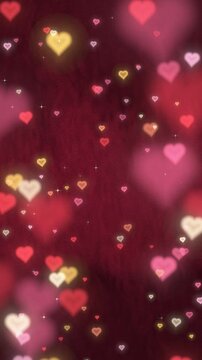 Heart shaped bokeh lights floating over deep red velvet, romantic Valentine's Day vertical video background with copy space, seamless loop