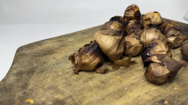 Single clove black garlic for herbal medicine on wooden board