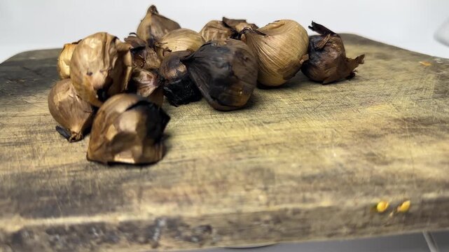 Single clove garlic for herbal medicine on rustic wooden board