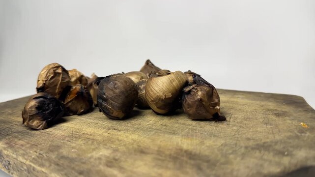 Single clove garlic for herbal health on rustic wooden board