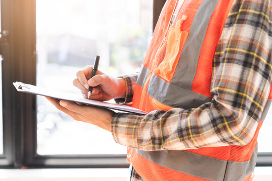 Building inspection asian contractor young man, male inspecting home, reconstructed construction, renovation or check defect, before finish handing it over to client, customer. Engineering worker.