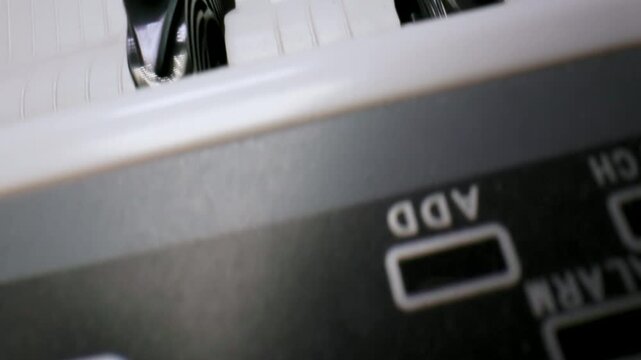 Extreme macro shot of 100 Euro banknotes in a cash counting machine