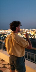 Obraz premium Young man on rooftop terrace holding a wine glass overlooking city lights at dusk for lifestyle background and social media banner