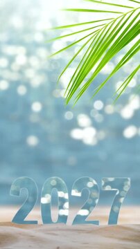 number 2027 year on sand beach with palm leaf and copy space, sunny nature background for travel season 2027, vacation, beach holidays