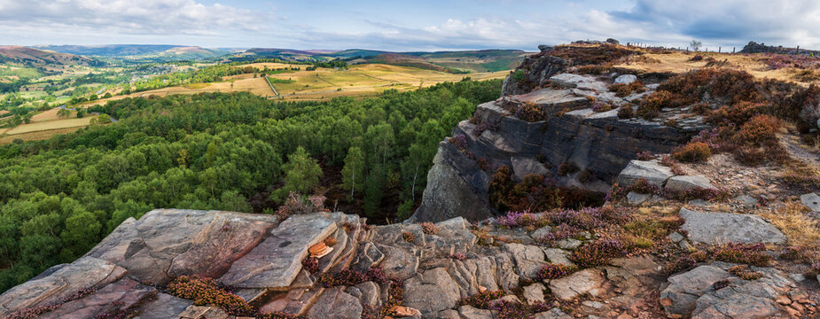Stunning Peak District landscape from Surprise View with vibrant heather and dappled sunlight over the hills
