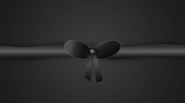 Elegant black gift ribbon with a decorative bow on a dark background