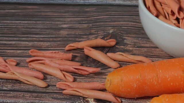 Italian hard fusilli pasta, orange carrot-colored healthy food
