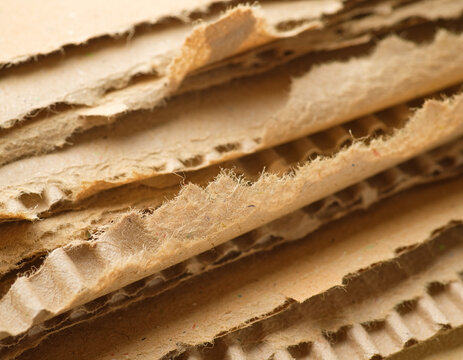 Stacked recycled corrugated cardboard sheets showing texture