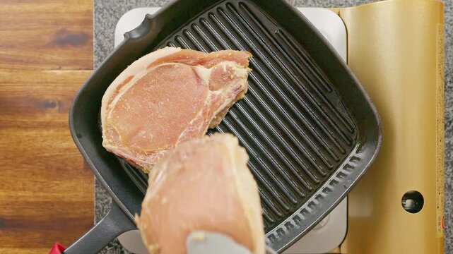 Adding Lemongrass-Marinated Pork Chops to a Hot Cast Iron Skillet