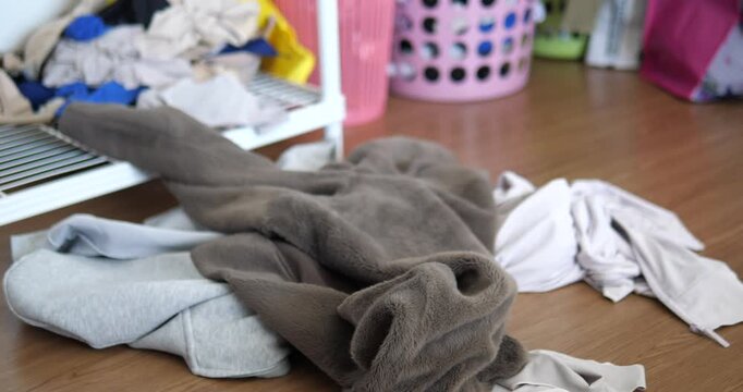 Close up of messy pile of dirty clothes on floor in bedroom