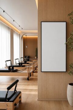 Blank vertical frame mockup in modern Pilates reformer studio