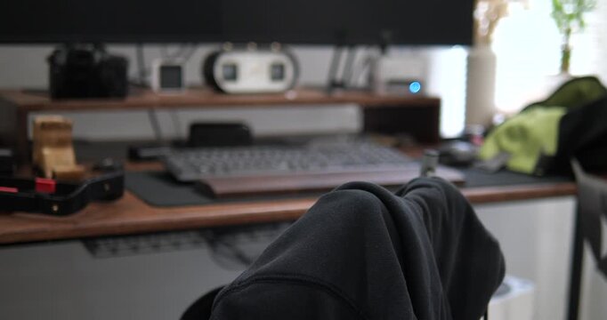 Perspective view of modern wooden desk setup with monitor and creative gear