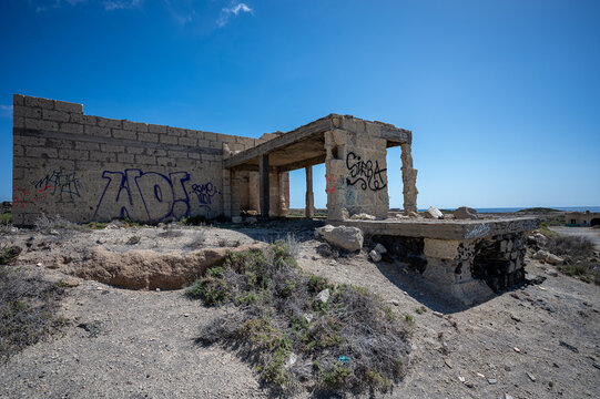 ABADES, TENERIFE, SPAIN - APRIL 24, 2025: Open concrete structure and graffiti covered wall at the abandoned Sanatorio de Abona.