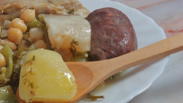 Plate of hot food with potatoes and chickpeas; healthy food.