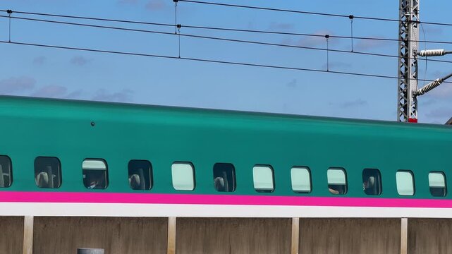 Coupled Hayabusa and Tsubasa Shinkansen Trains Passing Side by Side in Tokyo