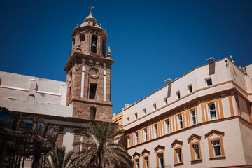 Historic clock tower and buildings in a sunny plaza © Bohdan