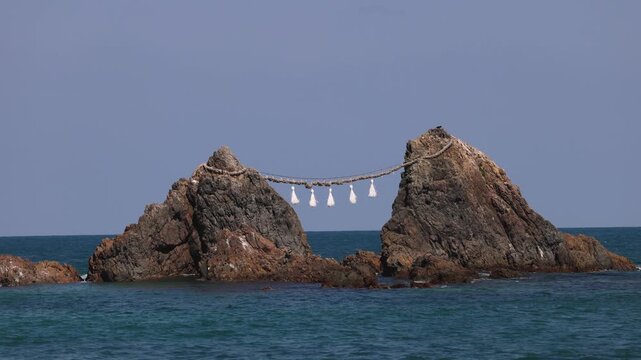 Sakurai Futamigaura shrine white Torii gate with Meoto Iwa Couple Stones, Married Couple Rocks with Shimenawa rope, Itoshima, Fukuoka prefecture, Japan, Kyushu island, landscape in a sunny day