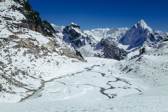 Majestic Himalayan Mountain Peak Rising Above Snowy Alpine Valley in Winter