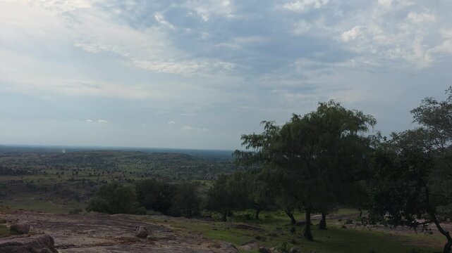 Panoramic Green Valley Beneath Cloudy Sky