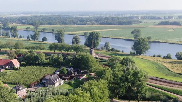 Aerial view of a traditional Dutch windmill and farmhouses drone shot