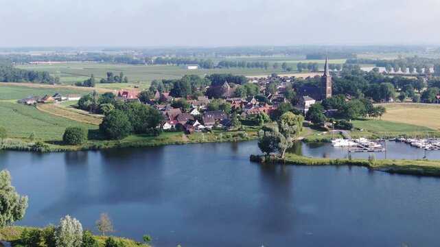 Aerial view of a Dutch village with a church spire drone shot