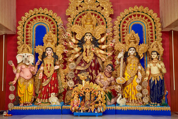 Fototapeta premium beautiful idol of Hindu Goddess Durga with sculpture of Laxmi, Ganesha, Saraswati and Kartikey, being worshipped inside a puja pandal. Shot during Durga puja festival in Kolkata. 