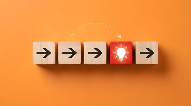 Row of wooden blocks with direction arrows and one red cube with glowing light bulb icon on orange background representing business innovation, creative thinking, leadership, and process success.