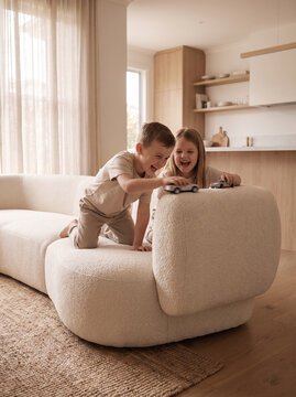 Lifestyle scenes with modern cream boucl&eacute; sofa &ndash; family, children, pet and relaxation in bright Scandinavian living room