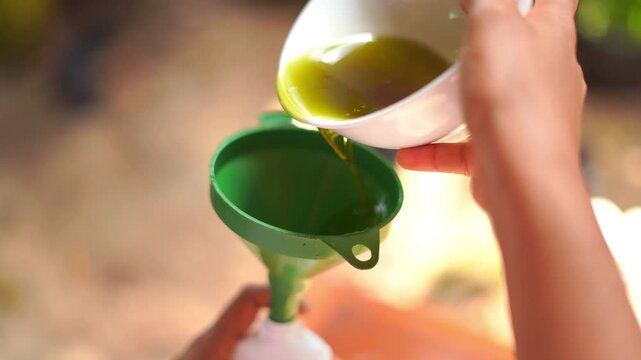 Cooking Oil Pouring Into Bottle Through Oil funnel for Controlled Filling