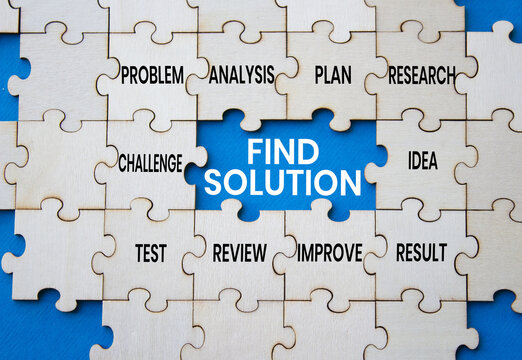 Find solution symbol. Concept words find solution on wooden puzzle pieces over blue background. Idea puzzle piece. Problem solving concept. Copy space.