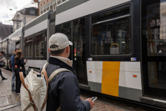 Man Tourist Boarding Tram Public Transport in Ghent Belgium