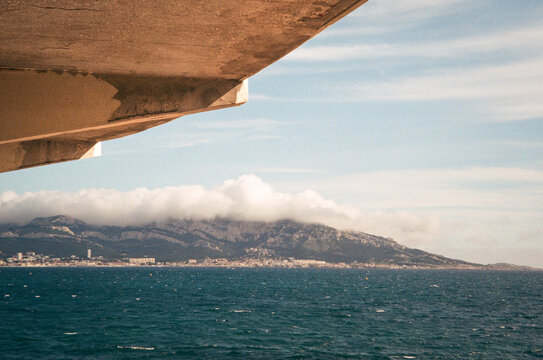 Coastal mountains framed beneath a concrete overhang