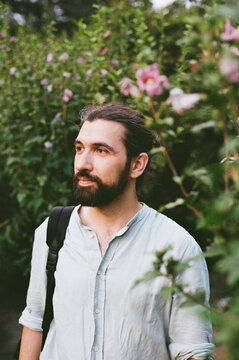 Man Standing in a Garden With Flowers During the Day