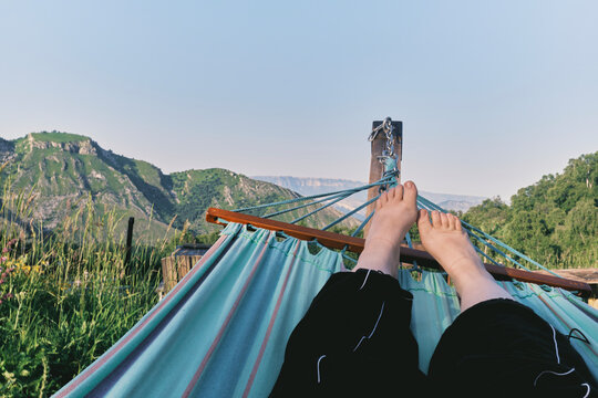 Relaxing on a hammock in a mountain landscape during daytime