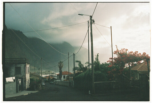 Village Street with Bougainvillea and Stormy Cliffs in Madeira