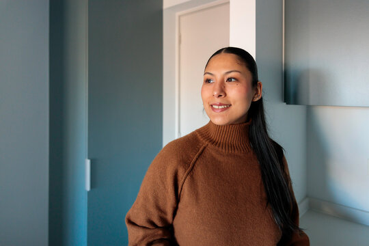 Young woman smiling in new apartment
