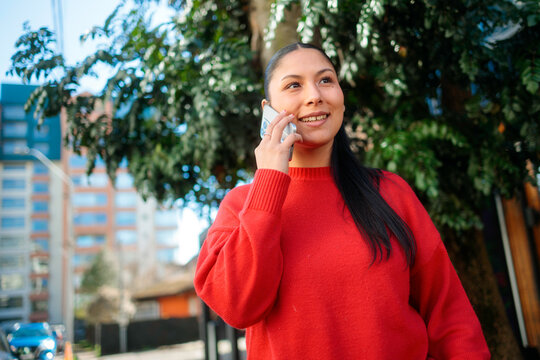 Smiling young woman on phone call